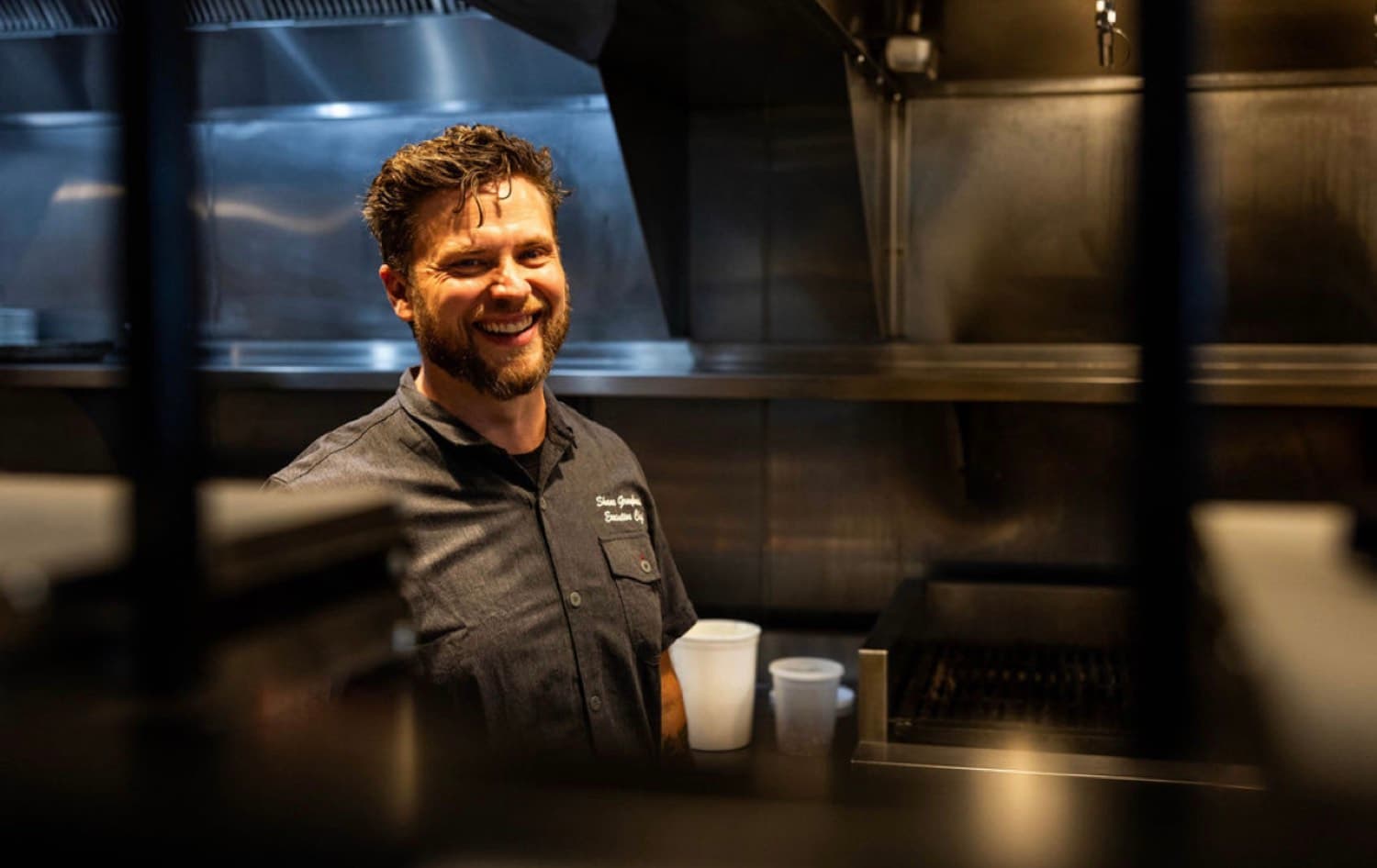 Chef Shane Graybeal smiling in a professional kitchen