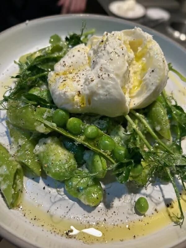 Burrata with peas, greens, and olive oil